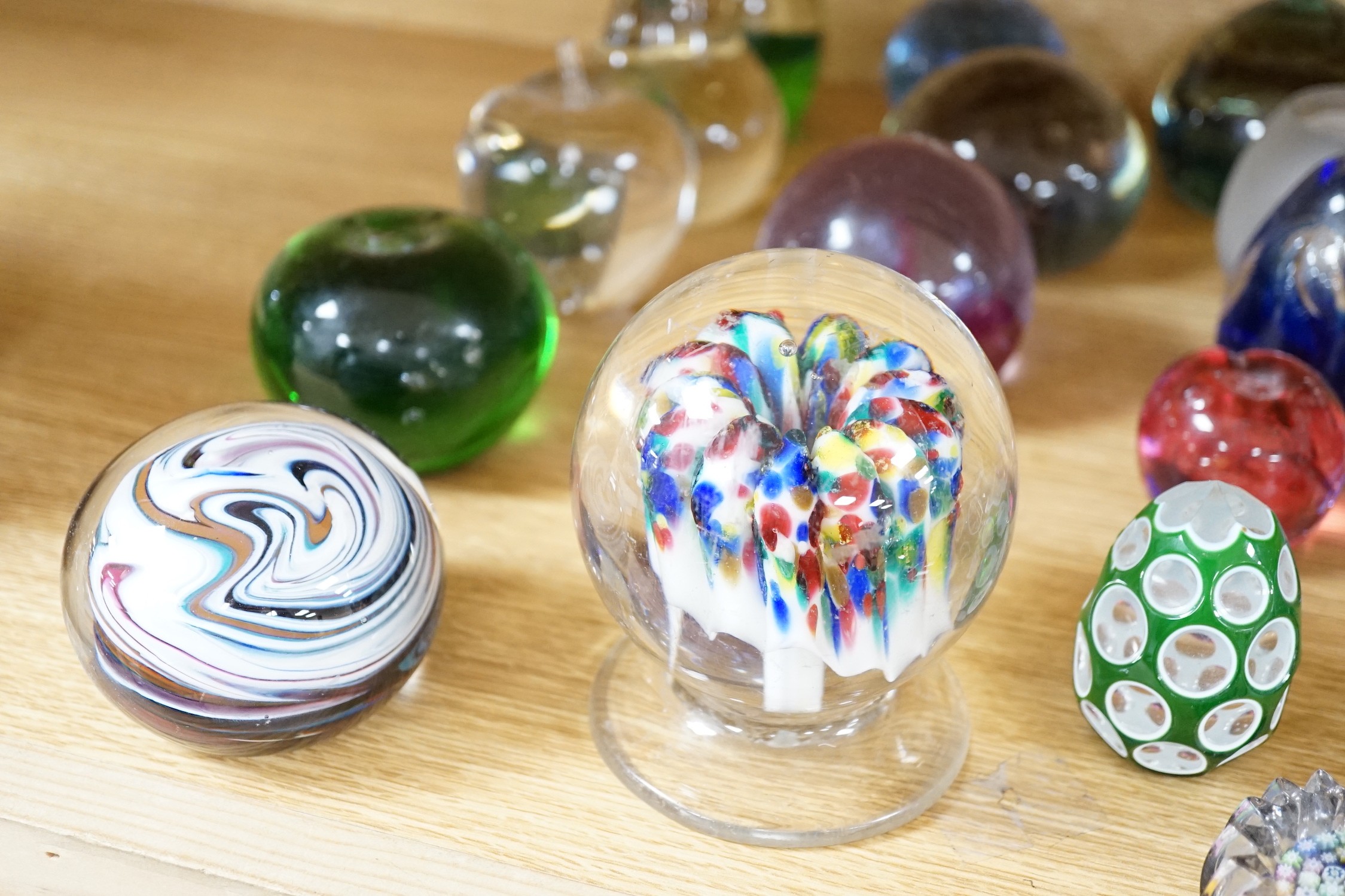 A collection of mixed paperweights to include a faceted floral Perthshire example, other Scottish floral and millefiori examples (Qty), tallest 12cms high